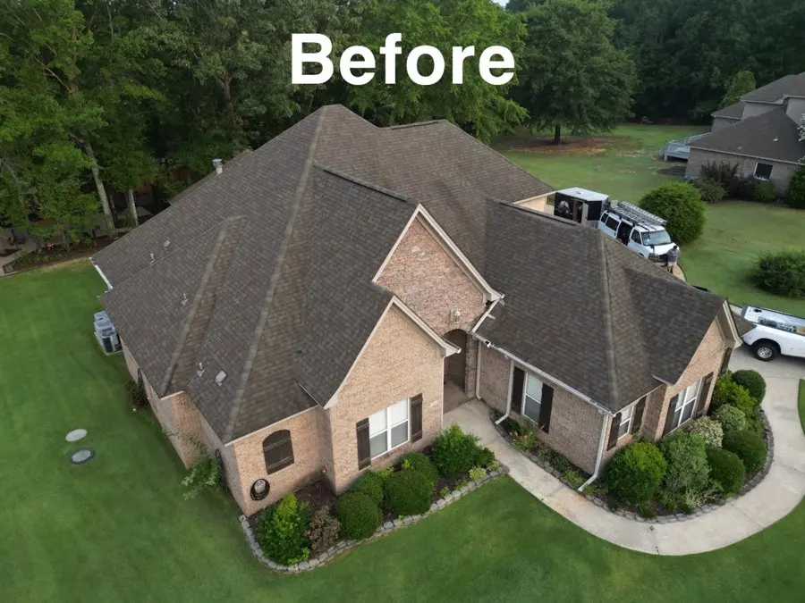 Drone view of a brick house before its new roof